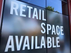 Close up of a sign in a window that reads "Retail Space Available."