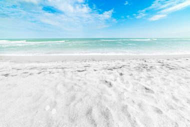 A white sand beach with turquoise water in Siesta Key, Florida. 