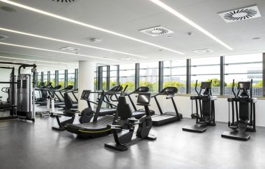 Interior of an empty commercial gym with exercise machines.
