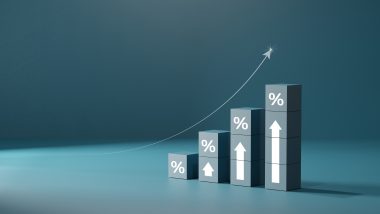 A three-dimensional illustration of bars with upward arrows and percentage signs that get progressively taller along with a swooping arrow over the top, showing an increasing return on investment.