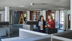 estate agent showing prospective tenant the office space